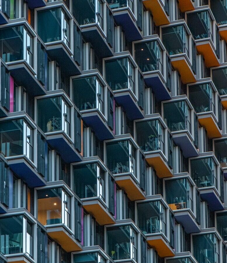 low-angle photo of orange and blue high-rise building
